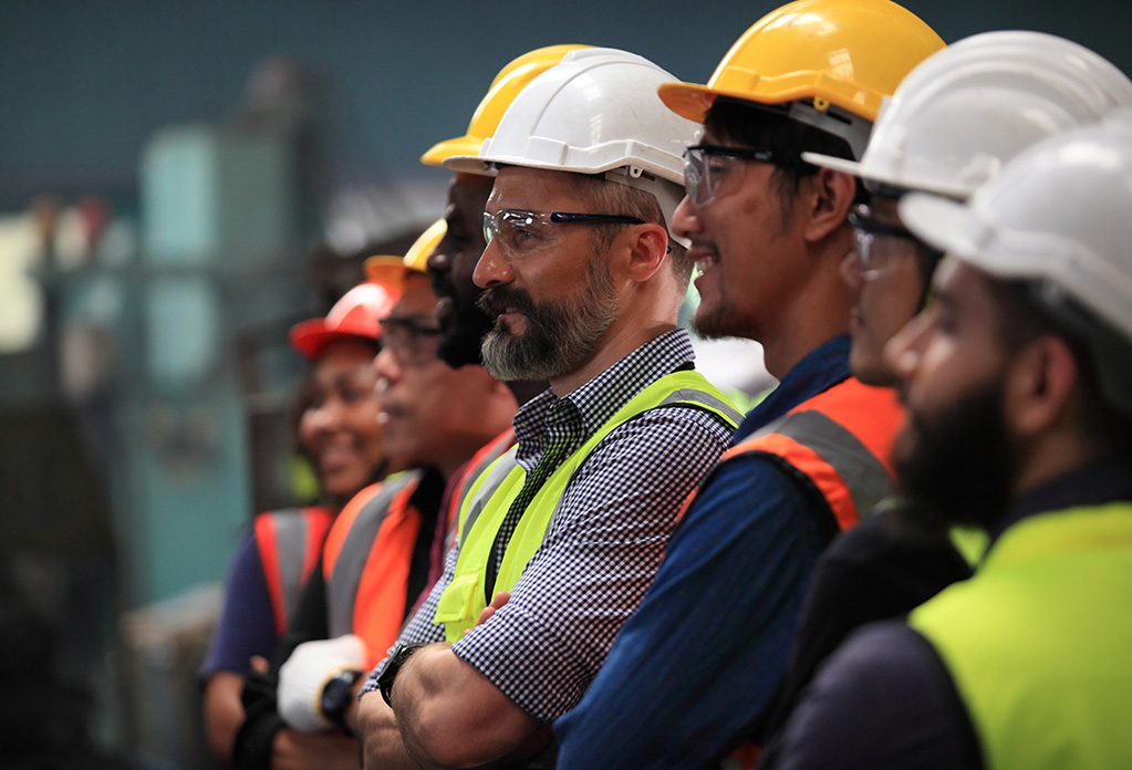 group of men wearing safety helmets and high visibility jackets