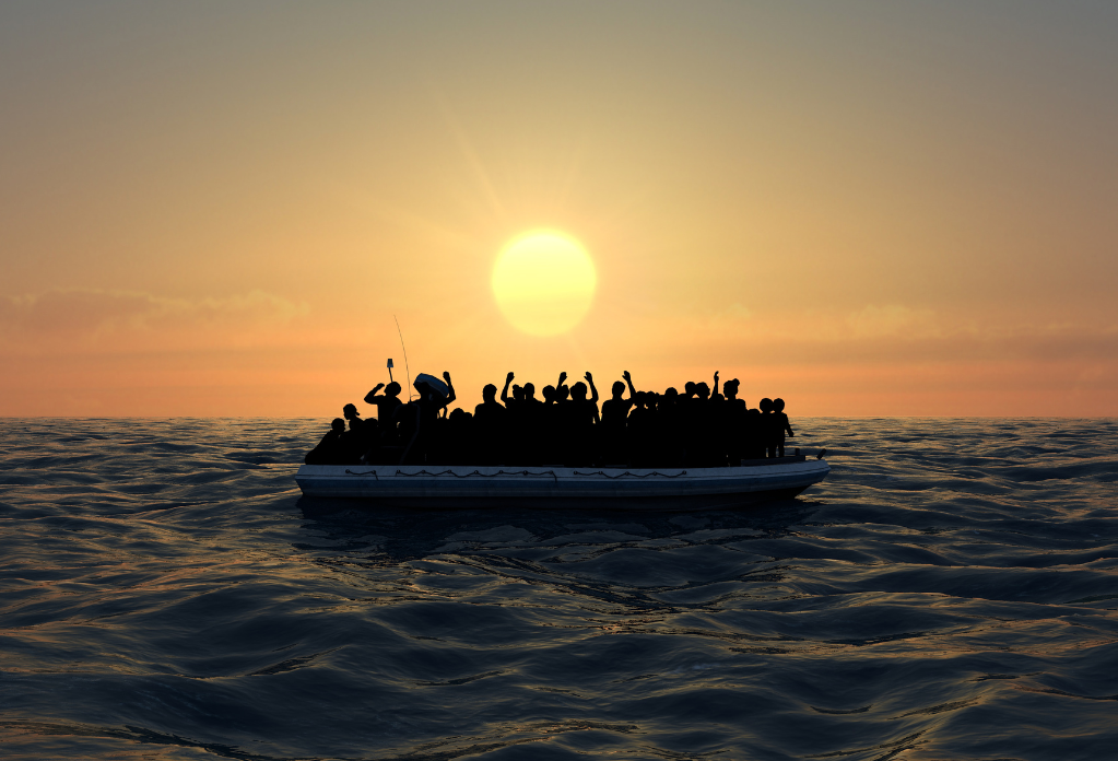 refugees crossing the channel in dinghy boat