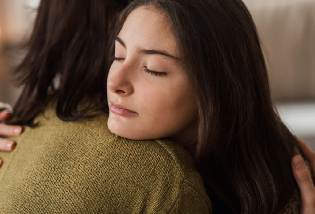 girl hugging her mother. big give christmas appeal 2023 - double your donation for free