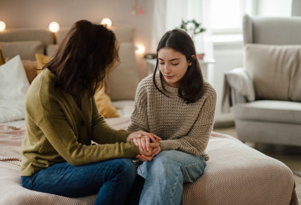 a young girl chatting with her mum