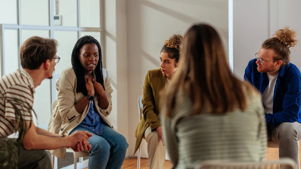 A group of people portraying survivors of modern slavery work on policy and research at anti-slavery charity Unseen